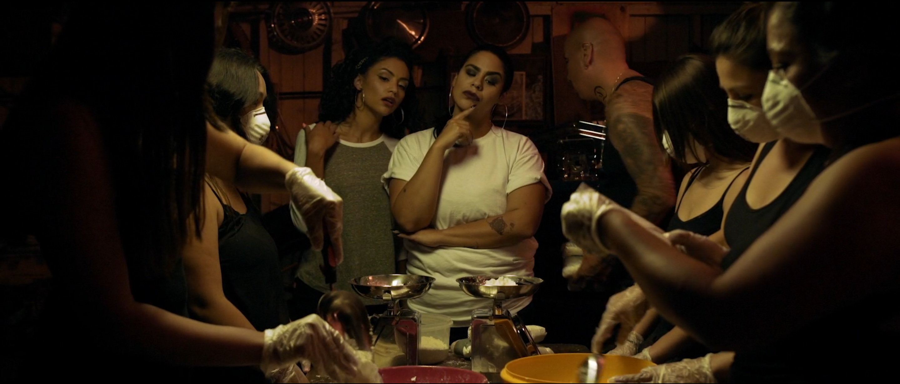 Group seated around a candlelit table at night in Avenge the Crows
